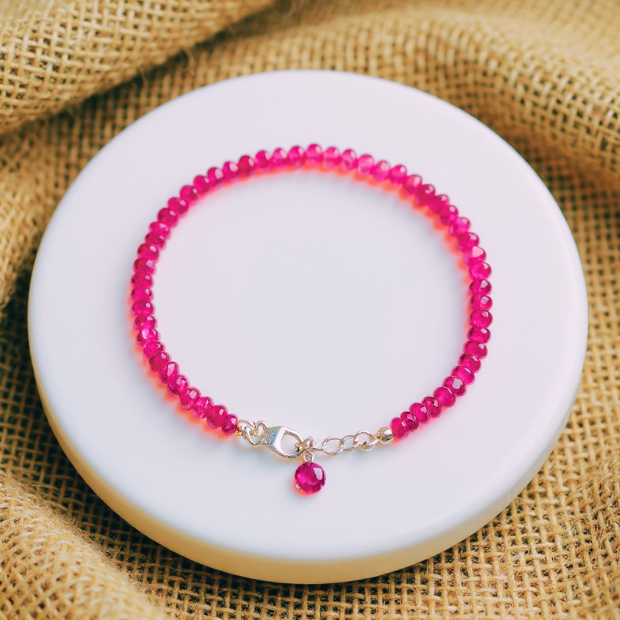 Buby beaded bracelet on a white plate with a burlap background