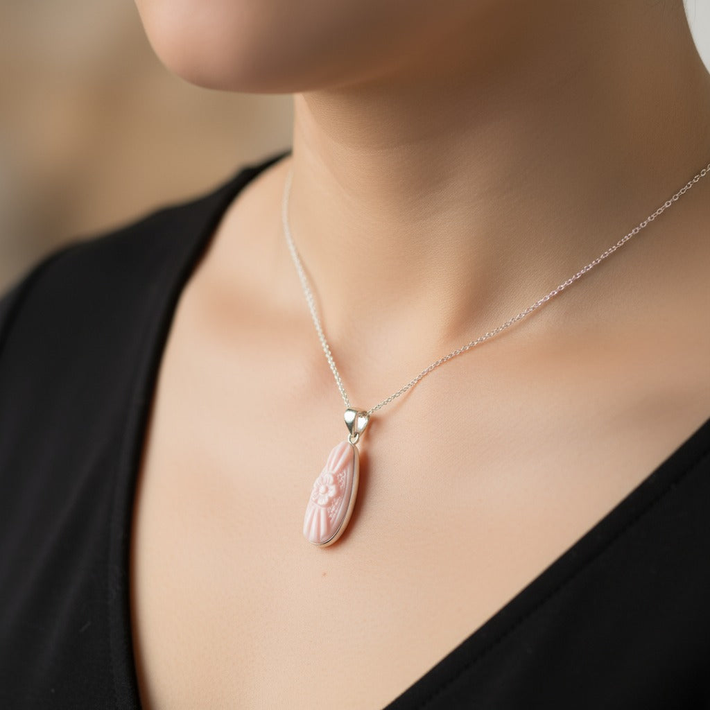 Necklace with a pink pendant on a blurred background