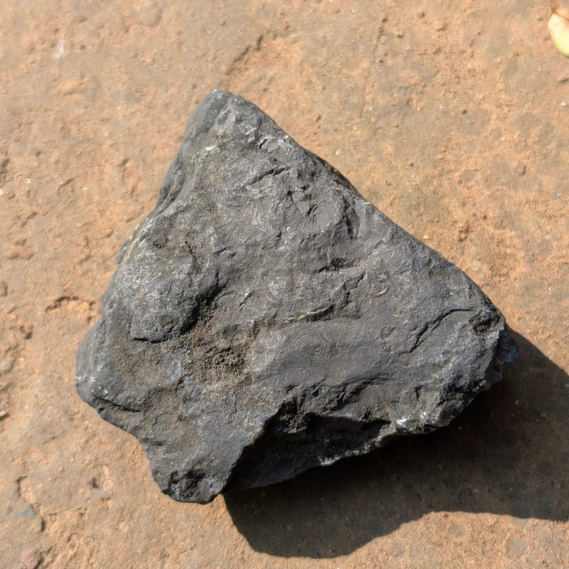 Black rock on a brown surface
