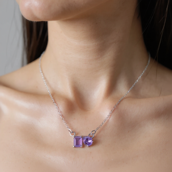 Necklace with purple gemstones worn by a person