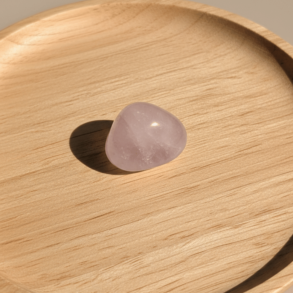 Rose quartz stone on a wooden surface