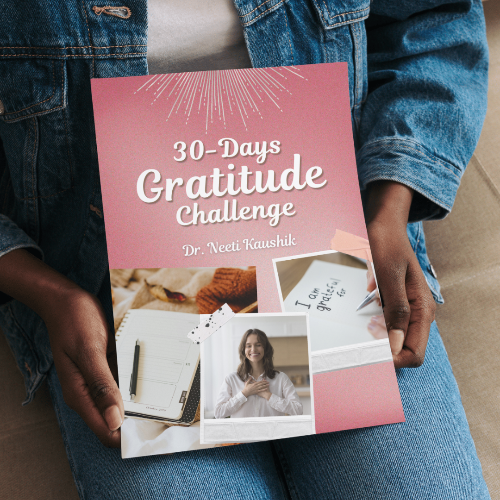 Book titled '30-Days Gratitude Challenge' held by a person wearing a denim jacket.