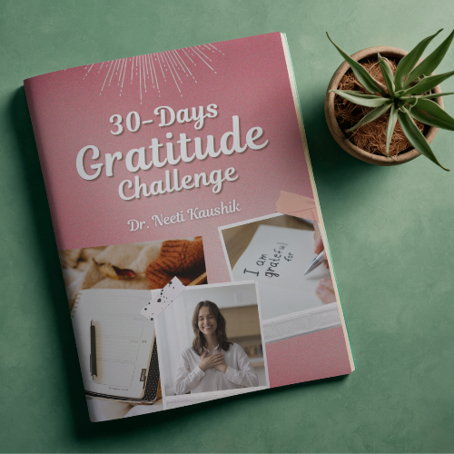 Book titled '30-Days Gratitude Challenge' by Dr. Neeti Kaushik on a green surface with a plant.