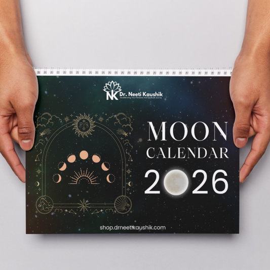 Moon calendar for 2026 held by two hands on a light gray background