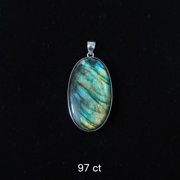 Labradorite pendant with silver setting on a black background