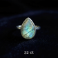 Teardrop-shaped labradorite ring on a dark background with '32 ct' text.