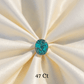 Turquoise stone on a white fabric background with '47 Ct' text