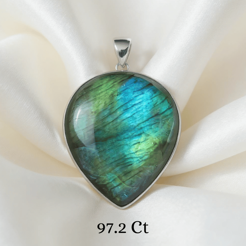 Labradorite pendant with a silver setting on a white fabric background