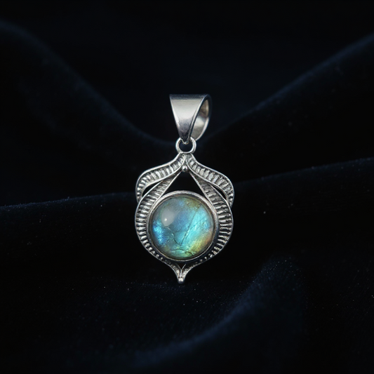 Silver pendant with a labradorite stone on a dark background
