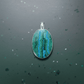 Green and blue pendant on a dark gray background