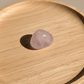 Rose quartz stone on a wooden surface