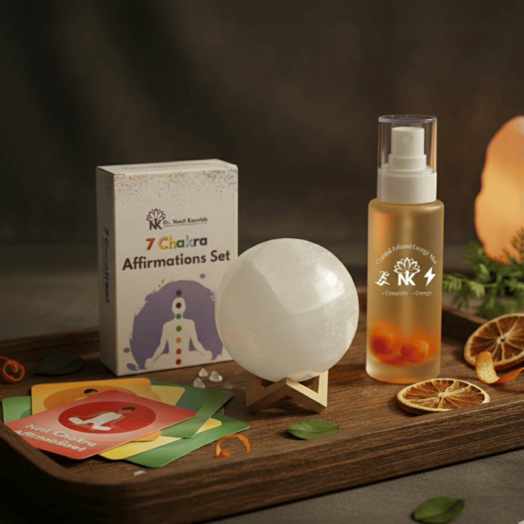 Set of '7 Chakra Affirmations' cards, a bottle with a label, a white sphere, and cards on a wooden surface.